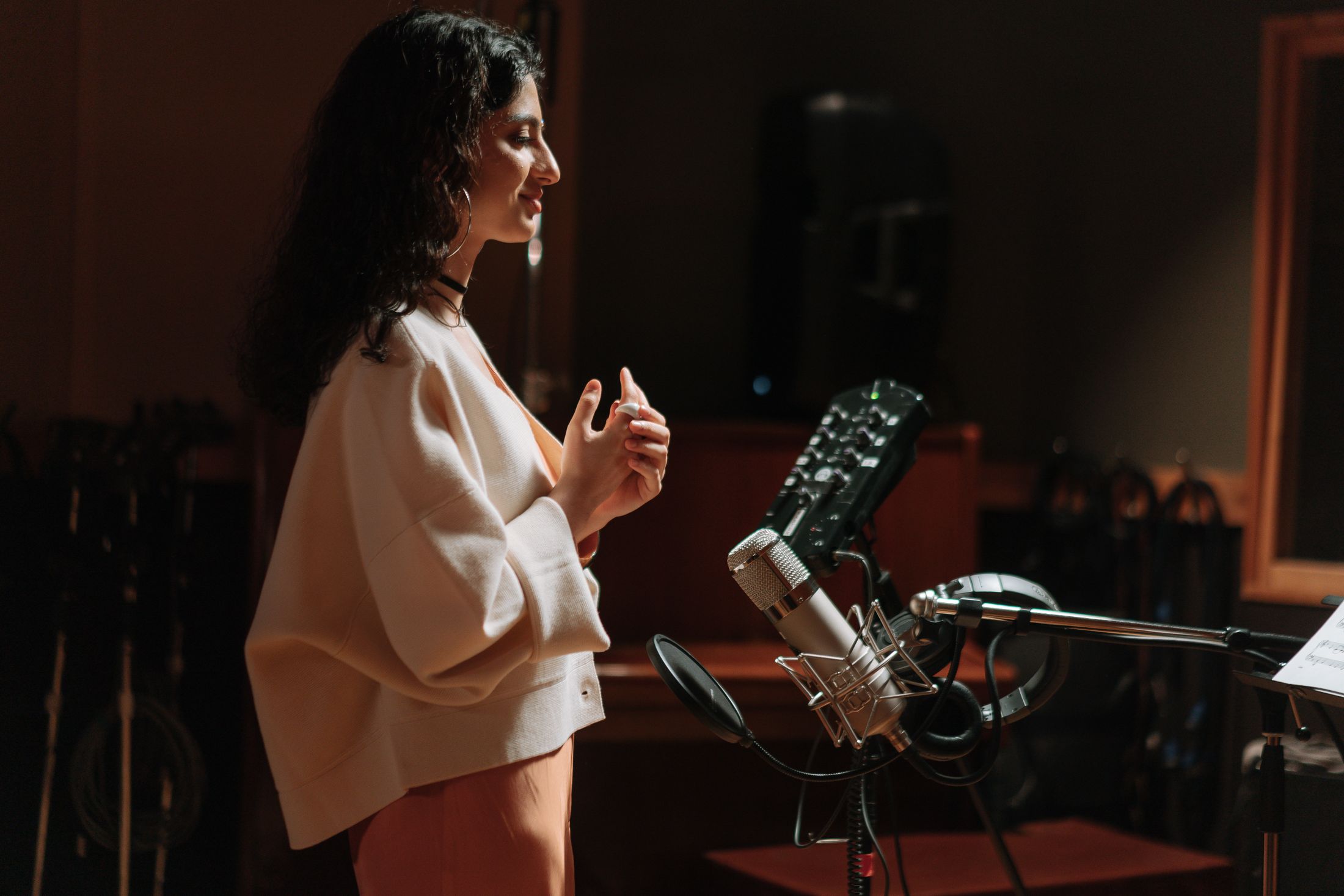 Singer working at a studio microphone